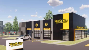 A Kwik Kar oil change and auto care building with a parking lot, a parked car, and clear signage on a sunny day.