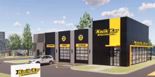 A Kwik Kar oil change and auto care building with a parking lot, a parked car, and clear signage on a sunny day.